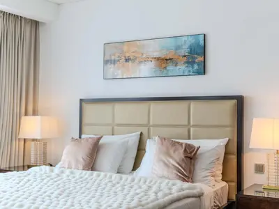 a bedroom with a large bed with white pillows at Dubai Marina Luxury Lifestyle - Sun Sand & Views in Dubai