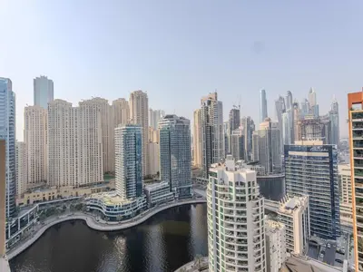 a view of a city with a bridge and buildings at Dubai Marina Luxury Lifestyle - Sun Sand & Views in Dubai