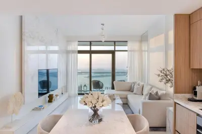 a living room with a couch and a table at Most Luxurious 2BR Apt Beach Access & Palm View in Dubai