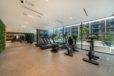 a gym with cardio equipment in a building at Grove Luxurious Stu Best community Art & Design in Dubai