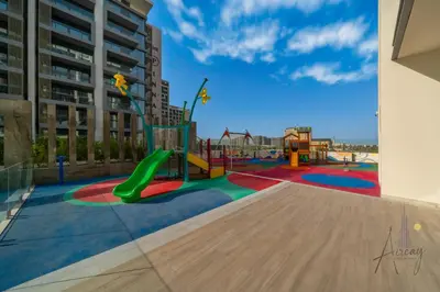 a playground with a slide in a building at Grove Luxurious Stu Best community Art & Design in Dubai