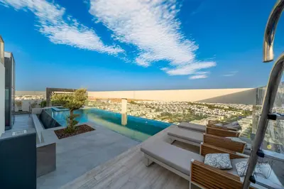 a balcony with a view of a city at Grove Luxurious Stu Best community Art & Design in Dubai