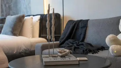 a living room with a coffee table and a couch at Grove Luxurious Stu Best community Art & Design in Dubai
