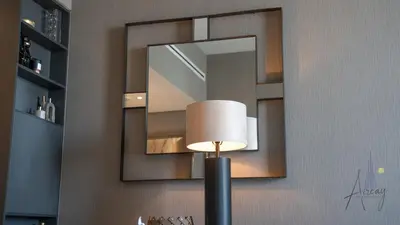 a mirror on the wall with a lamp in front of it at GroveLuxurious 1BR BEST communityArt & Design in Dubai