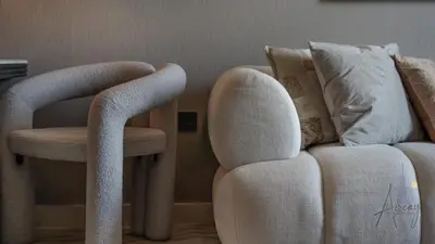 a living room with two chairs and a couch at GroveLuxurious 1BR BEST communityArt & Design in Dubai