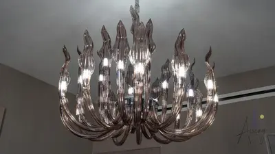 a silver chandelier hanging from a ceiling at GroveLuxurious 1BR BEST communityArt & Design in Dubai