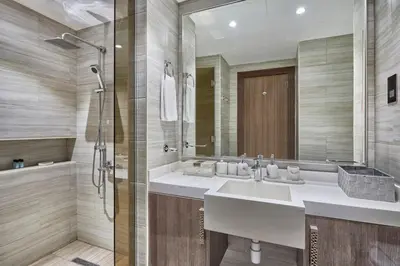 a bathroom with a sink and a shower at Sky-High Luxury 1BR in 27th Floor MBL Residence in Dubai