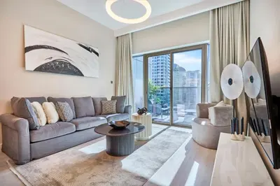 a living room with a couch and a large window at Sky-High Luxury 1BR in 27th Floor MBL Residence in Dubai