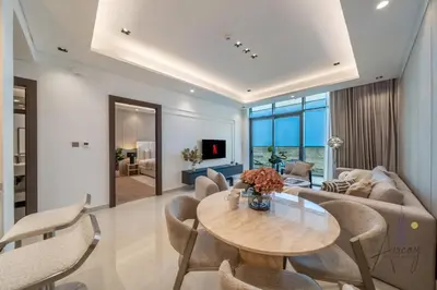 a living room with a table and chairs at Luxe Haven 1BR8min drive DubaiMall & BurjKhalifa in Dubai