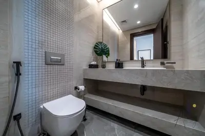 a bathroom with a toilet and a sink and a mirror at Luxe Haven 1BR8min drive DubaiMall & BurjKhalifa in Dubai