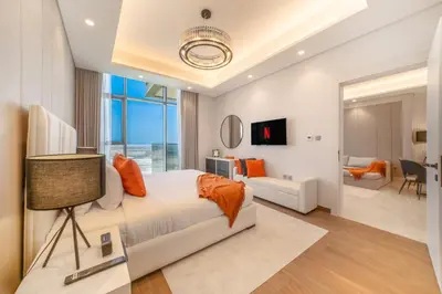a bedroom with a bed and a living room at Luxury Comfort 1BRNear Dubai Mall & Burj Khalifa in Dubai