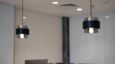 two lights hanging from the ceiling in a kitchen at Luxury Comfort 1BRNear Dubai Mall & Burj Khalifa in Dubai