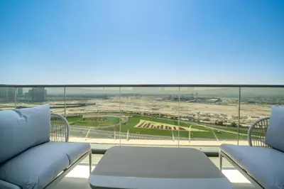 a balcony with two couches and a view of a stadium at Luxury Comfort 1BRNear Dubai Mall & Burj Khalifa in Dubai