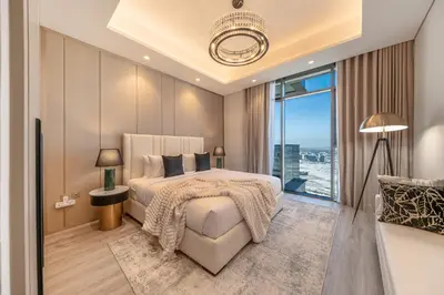 a bedroom with a large bed and a large window at GEM 2BR Prime Location 8 Min to Burj Khalifa in Dubai