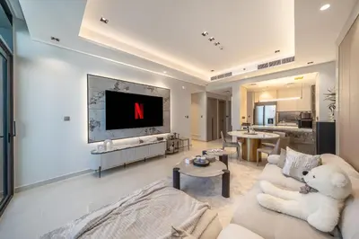 a large living room with a tv and a couch at GEM 2BR Prime Location 8 Min to Burj Khalifa in Dubai