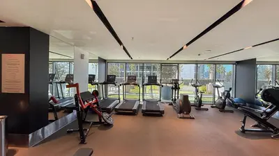 a gym with several treadmills and elliptical machines at GEM 2BR Prime Location 8 Min to Burj Khalifa in Dubai
