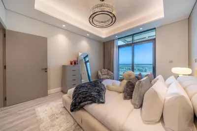a living room with a couch with a teddy bear on it at GEM 2BR Prime Location 8 Min to Burj Khalifa in Dubai