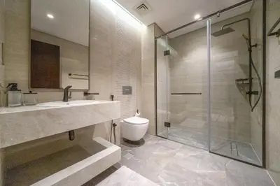 a bathroom with a shower and a sink and a toilet at Sky-High 2BR Escape Stylish Stay Near Dubai Mall in Dubai