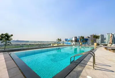 a swimming pool on top of a building at Sky-High 2BR Escape Stylish Stay Near Dubai Mall in Dubai