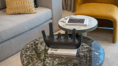 a living room with a table and a couch at Sky-High 2BR Escape Stylish Stay Near Dubai Mall in Dubai