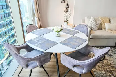 a table and chairs in a living room with a couch at Luxury 1 Bedroom Apartment in Dubai Marina 5 Star in Dubai