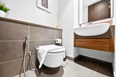 a bathroom with a white toilet and a sink at Luxury 1 Bedroom Apartment in Dubai Marina 5 Star in Dubai
