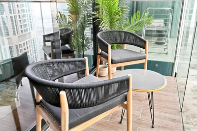 two chairs and a table on a balcony with plants at Luxury 1 Bedroom Apartment in Dubai Marina 5 Star in Dubai