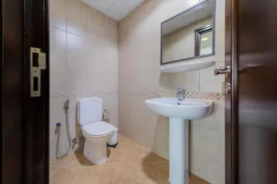 a bathroom with a toilet and a sink at Royal Oceanic Elegant 2BR with Marina View in Dubai