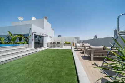 a backyard with a lawn and a swimming pool at Luxurious Design Boutique Studio Hideaway JVC in Dubai