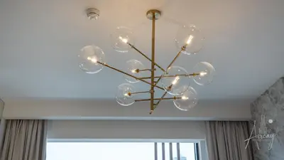 a chandelier hanging from a ceiling in a room at Luxurious Design Boutique Studio Hideaway JVC in Dubai