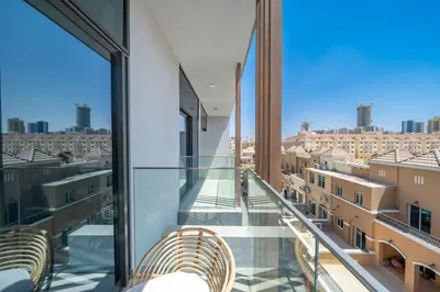 a balcony with two chairs and a view of the city at Luxurious Design Boutique Studio Hideaway JVC in Dubai