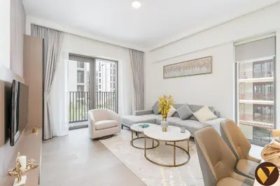 a living room with a couch and a table at Vogue Creek Beach Rosewater Waterfront Living close to Downtown, Burj Khalifa and Dubai mall, Two Bedroom Apartment with Balcony and Vibrant Community View, Private Manmade Beach, Access to all Amenities in Sabkhah