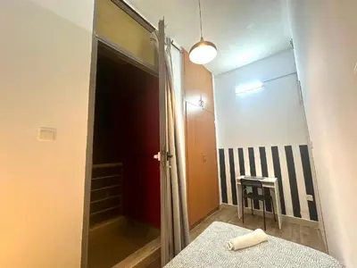 a bathroom with a mirror and a door to a room at delightful Partition Room Barsha Heights Tecom in Dubai