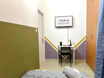 a room with a desk with a computer on it at Pleasing Partition Room Barsha Heights tecom in Dubai
