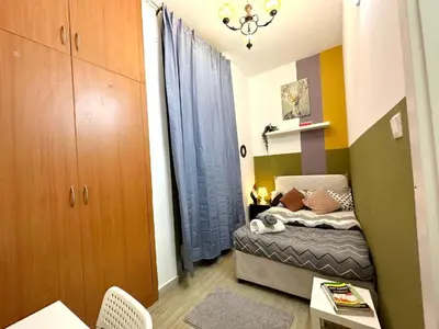 a small bedroom with a small bed in a room at Pleasing Partition Room Barsha Heights tecom in Dubai