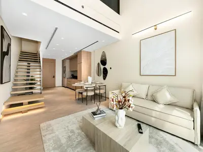 a living room with a couch and a table at Brand New Luxury Duplex in 5 Star JVC Development in Dubai