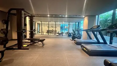a gym with several tread machines in a room at Brand New Luxury Duplex in 5 Star JVC Development in Dubai