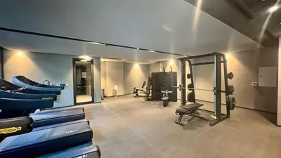 a gym with several treadmills and machines in it at Brand New Luxury Duplex in 5 Star JVC Development in Dubai