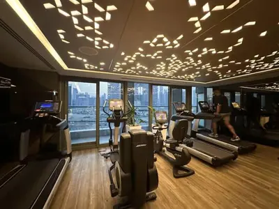 a gym with a person running on treadmills at Luxurious paramount 2BR with Pool,Gym, Sauna & Bar 10 mins to Burj Khalifa in Dubai