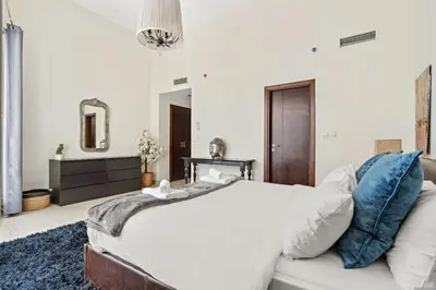 a bedroom with a large bed and a mirror at VayK - Chic 1BR with Marina View in Park Island in Dubai