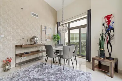 a dining room with a table and chairs at VayK - Chic 1BR with Marina View in Park Island in Dubai
