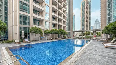 a swimming pool in the middle of a building at Chic Studio Apartment, Pool and Balcony, Steps to Burj Khalifa in Dubai