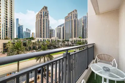 a balcony with a table and a view of the city at Chic Studio Apartment, Pool and Balcony, Steps to Burj Khalifa in Dubai