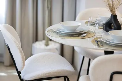 a white table with white cups and saucers on it at Stylish Apartment - Private Beach - Port de La Mer in Dubai