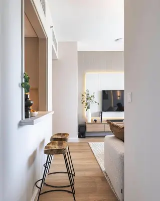 a living room with a stool and a bedroom at The Burj View Suite Luxury 1BR Full Burj Views in Dubai