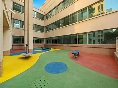 a large building with a playground in front of it at The Burj View Suite Luxury 1BR Full Burj Views in Dubai