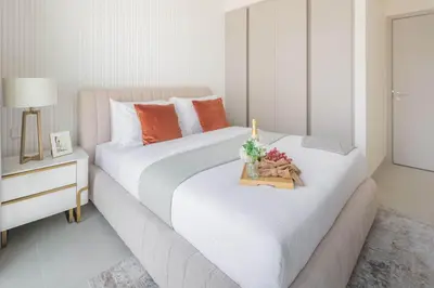a bedroom with a large white bed with flowers on it at Frank Porter - Creek Palace in Dubai