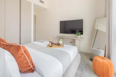 a white room with two beds and a television at Frank Porter - Creek Palace in Dubai