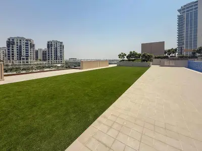 a green lawn on the roof of a building at Frank Porter - Creek Palace in Dubai