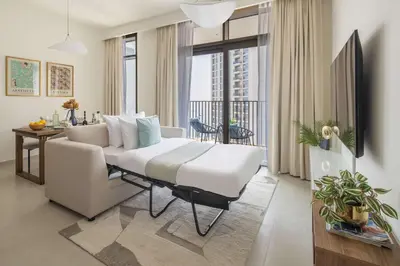 a bedroom with a bed and a couch in a room at Frank Porter - Creek Palace in Dubai